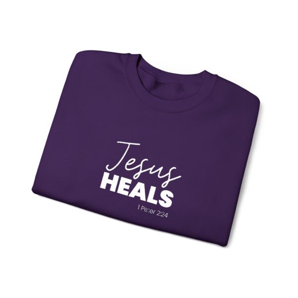 Purple unisex sweatshirt with 'Jesus Heals' and Bible verse 1 Peter 2:24.