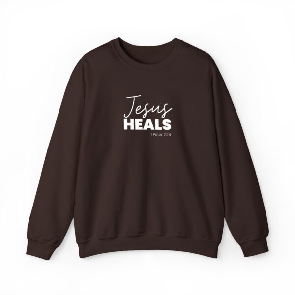 Black sweatshirt with Jesus heals text and Bible verse reference.
